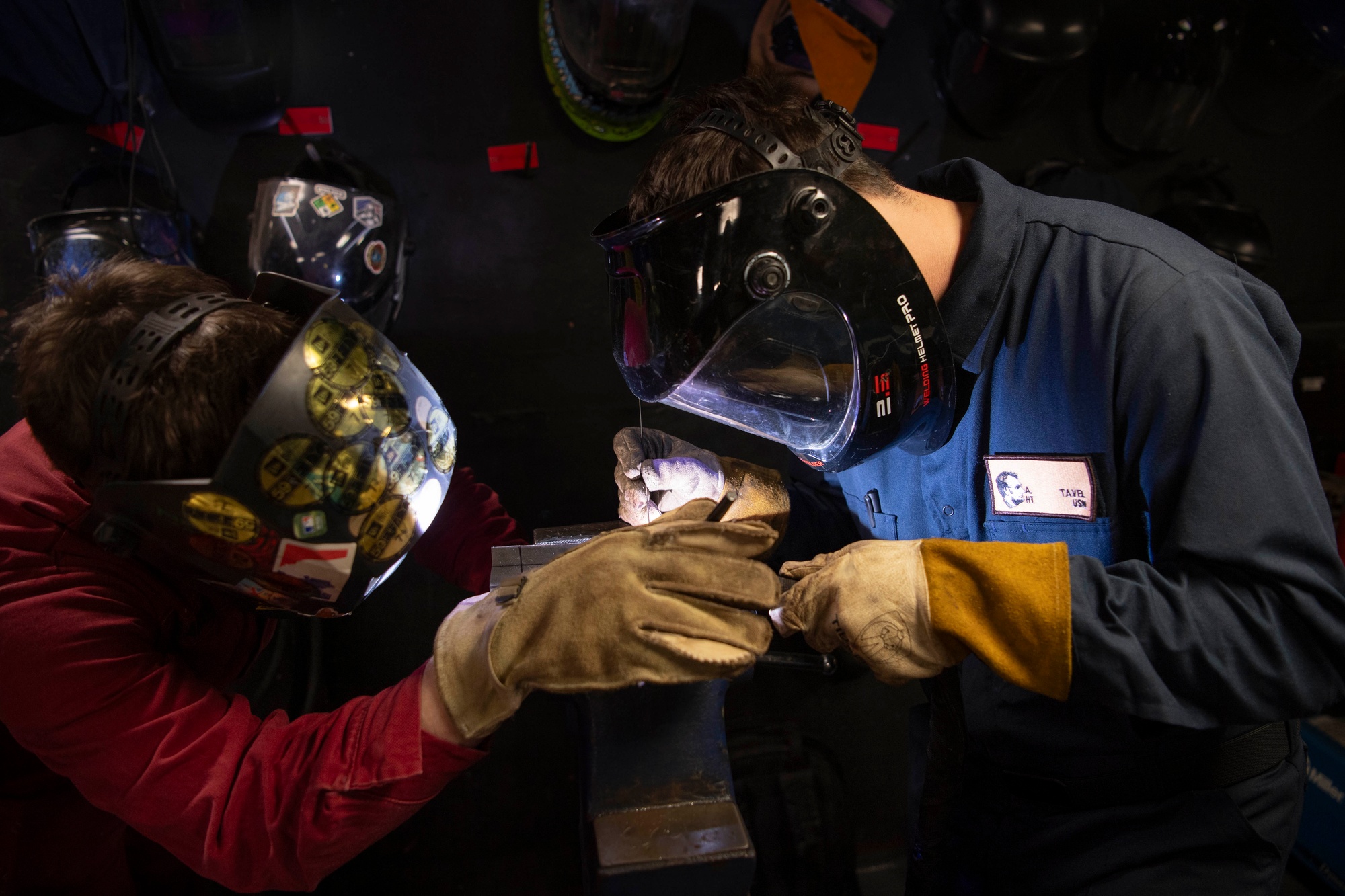 Two sailors weld together aboard USS Abraham Lincoln (CVN 72)